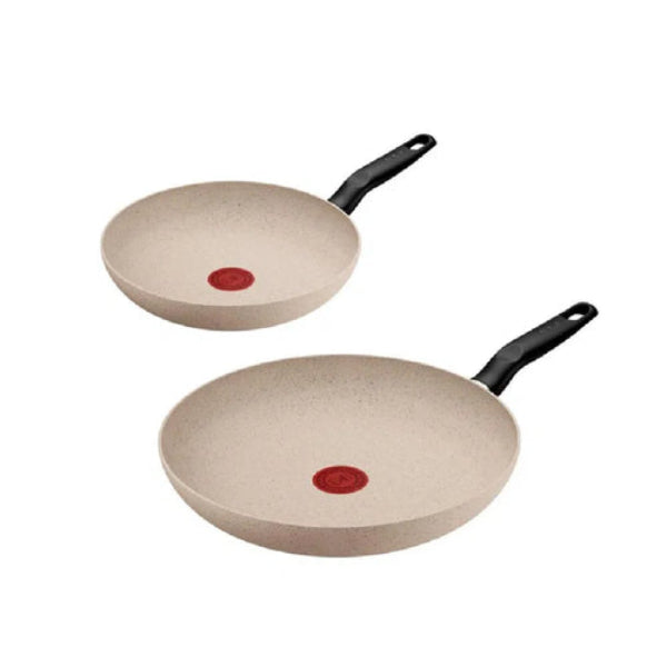 Two beige frying pans with black handles on a white background