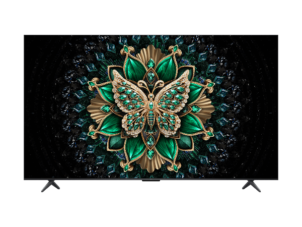 Decorative butterfly with green gemstones on a dark background