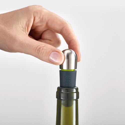 Hand using a wine bottle stopper on a white background