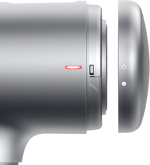 Close-up of a silver hair dryer with control buttons on a white background
