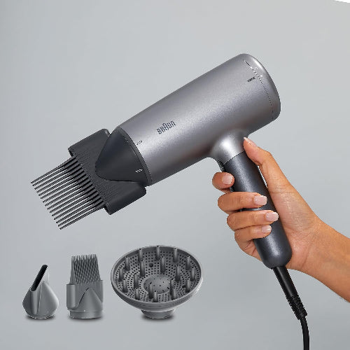Braun hair dryer with attachments on a gray background