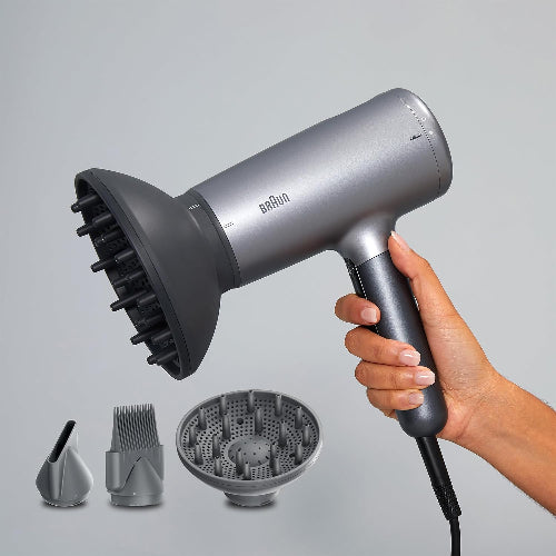 Braun hair dryer with attachments on a gray background