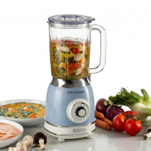 Blue blender with a glass container filled with ingredients on a white background